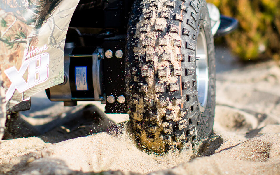 Magic Mobility Extreme X8 powerchair in the sand 